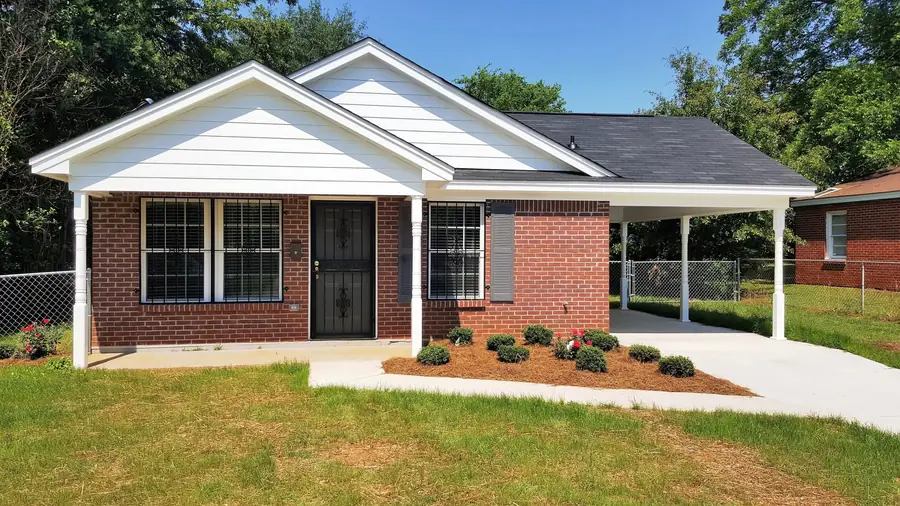Restored brick home with a new porch and carport after damage repairs